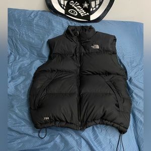 Black north face puffer vest jacket.